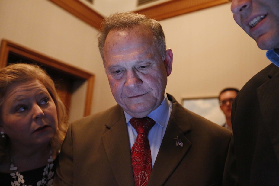 caption: Republican U.S. Senate candidate Roy Moore, center, looks at election returns with staff during an election-night watch party at the RSA activity center, Tuesday, Dec. 12, 2017, in Montgomery, Ala.