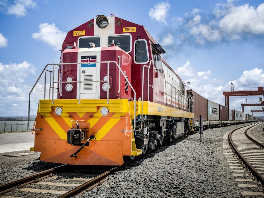 caption: China's New Silk Road project is lending out billions to countries in Central Asia, the Middle East and Africa to build and upgrade railways, ports, pipelines, power grids and highways. Above: A Kenya Railways train pulls shipping containers as it departs from the Mombasa port station.