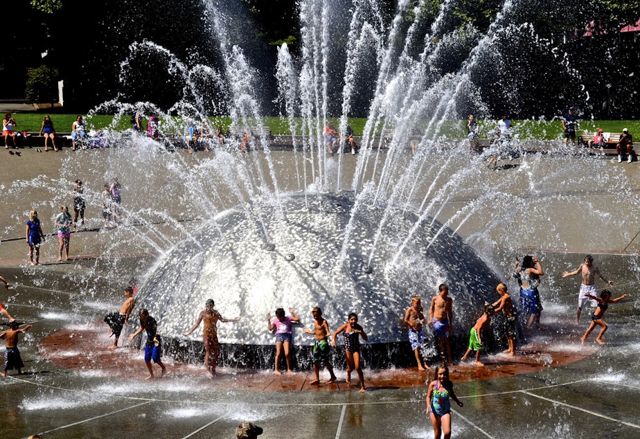 caption: People cool off in Seattle Center's International Fountain.
