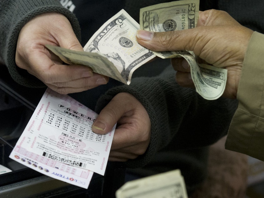 caption: A customer purchases Powerball lottery tickets in Washington in 2012. The Maryland Lottery says a retired utility worker has won a $2 million prize for the second time since 2018.