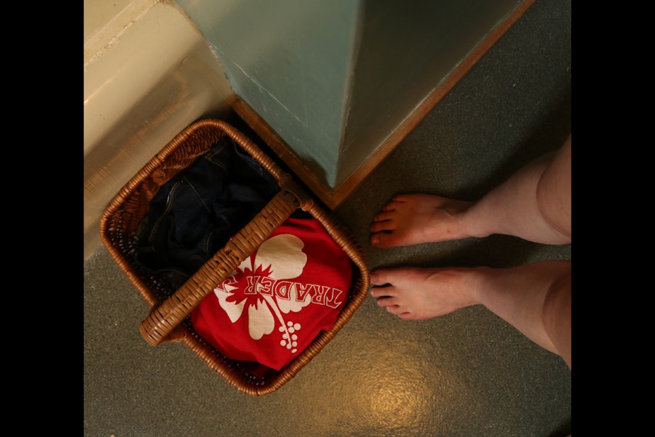 caption: After work, I gather my clothes into a confined area and take a shower. Here, my clothes and mask are ready for me to take them downstairs to the washing machine. 