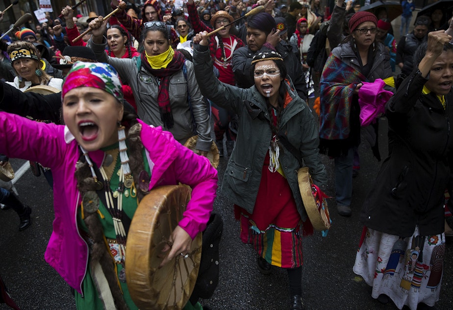 Mariana Harvey, left, and Leslie Jimenez, center, lead the Indigenous People's Day march and celebration on Monday, October 8, 2018, on 5th Avenue in Seattle.