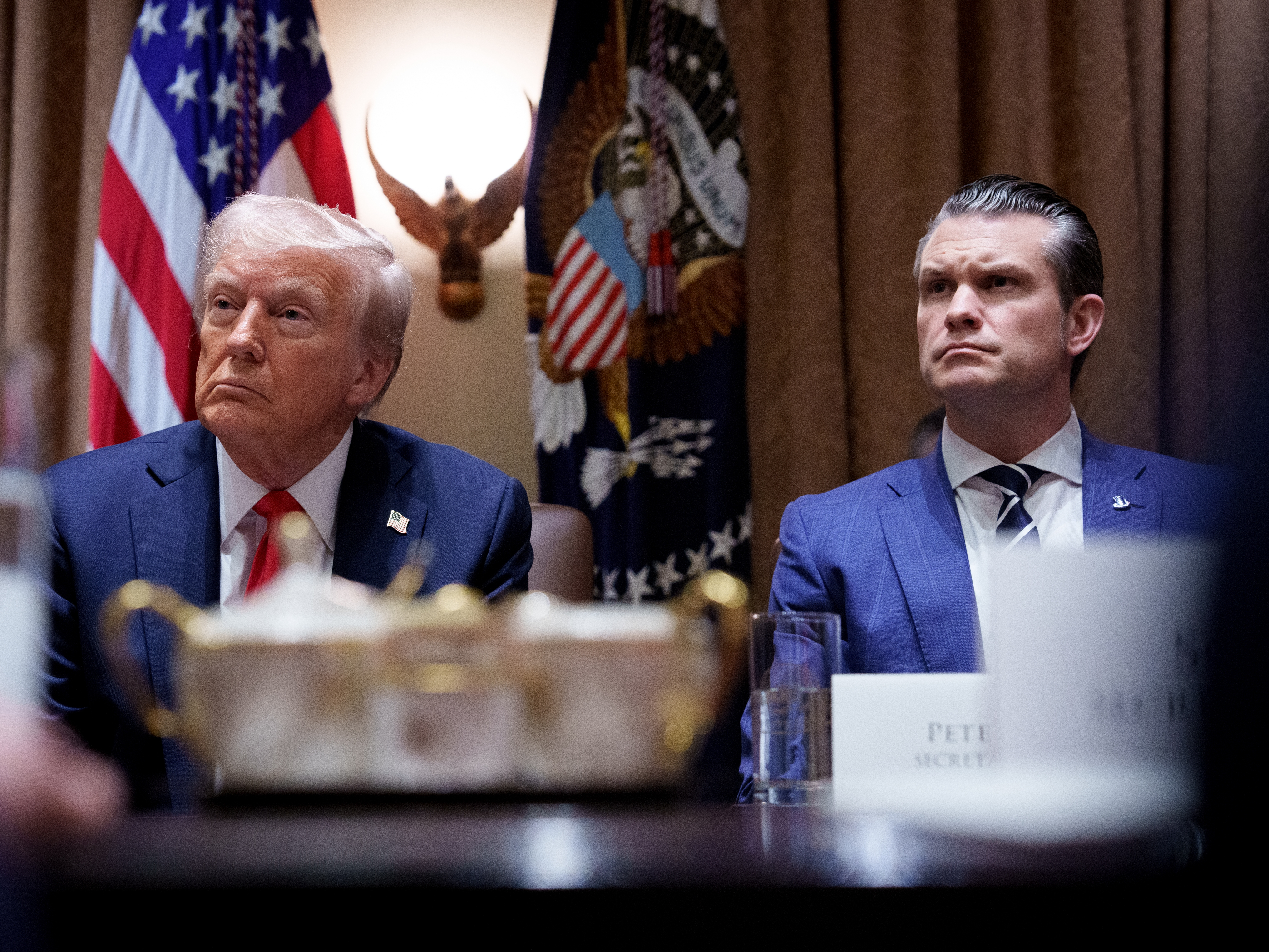 caption: President Trump and Defense Secretary Pete Hegseth appear during a Cabinet meeting at the White House on Feb. 26.
