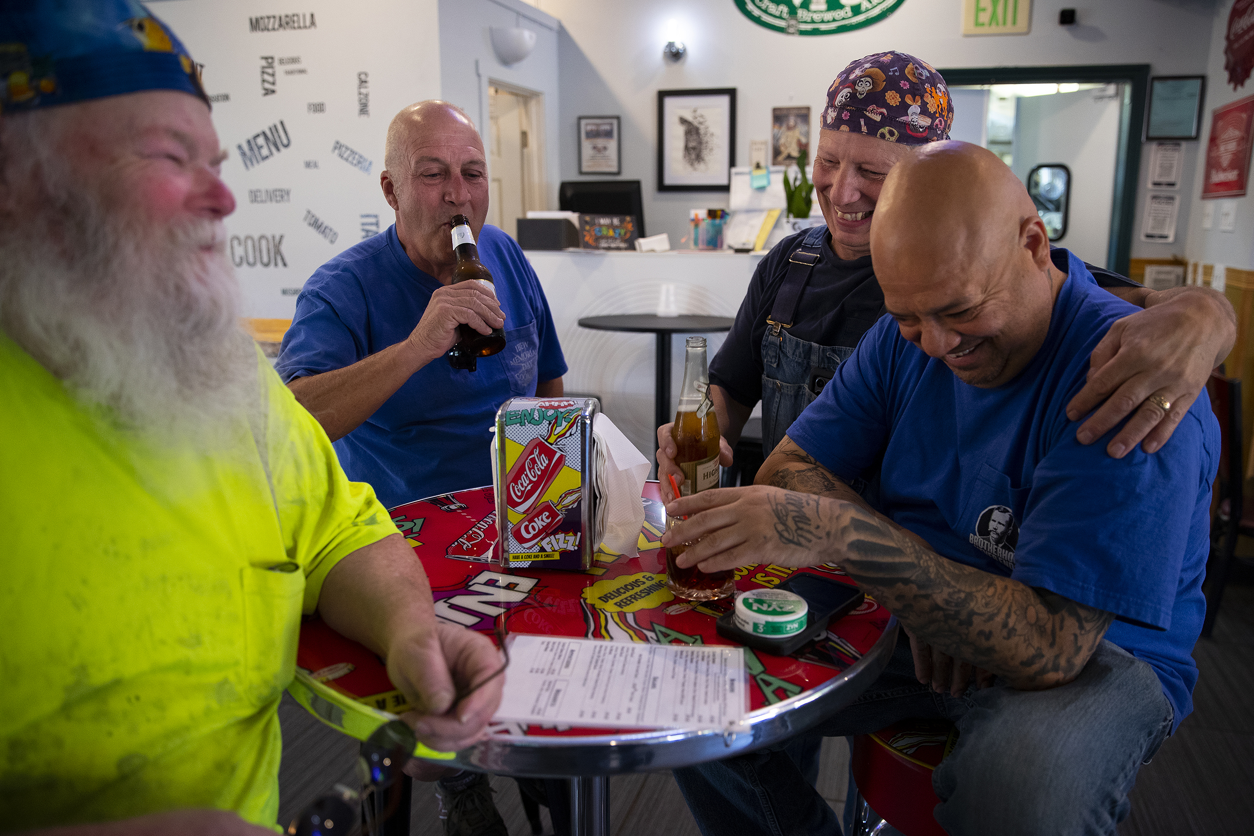 caption: From left, electricians Mike Kane, Rick Lebel, Scott Young and Jimmy Ortega, laugh together at IBEW Brotherhood Night at Monkey N’Around Pizza on Thursday, July 17, 2025, in Quincy, Washington. 