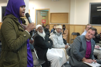 caption: High school student Ifrah Hirsi speaks to Sen. Maria Cantwell at a community meeting in Tuwkila