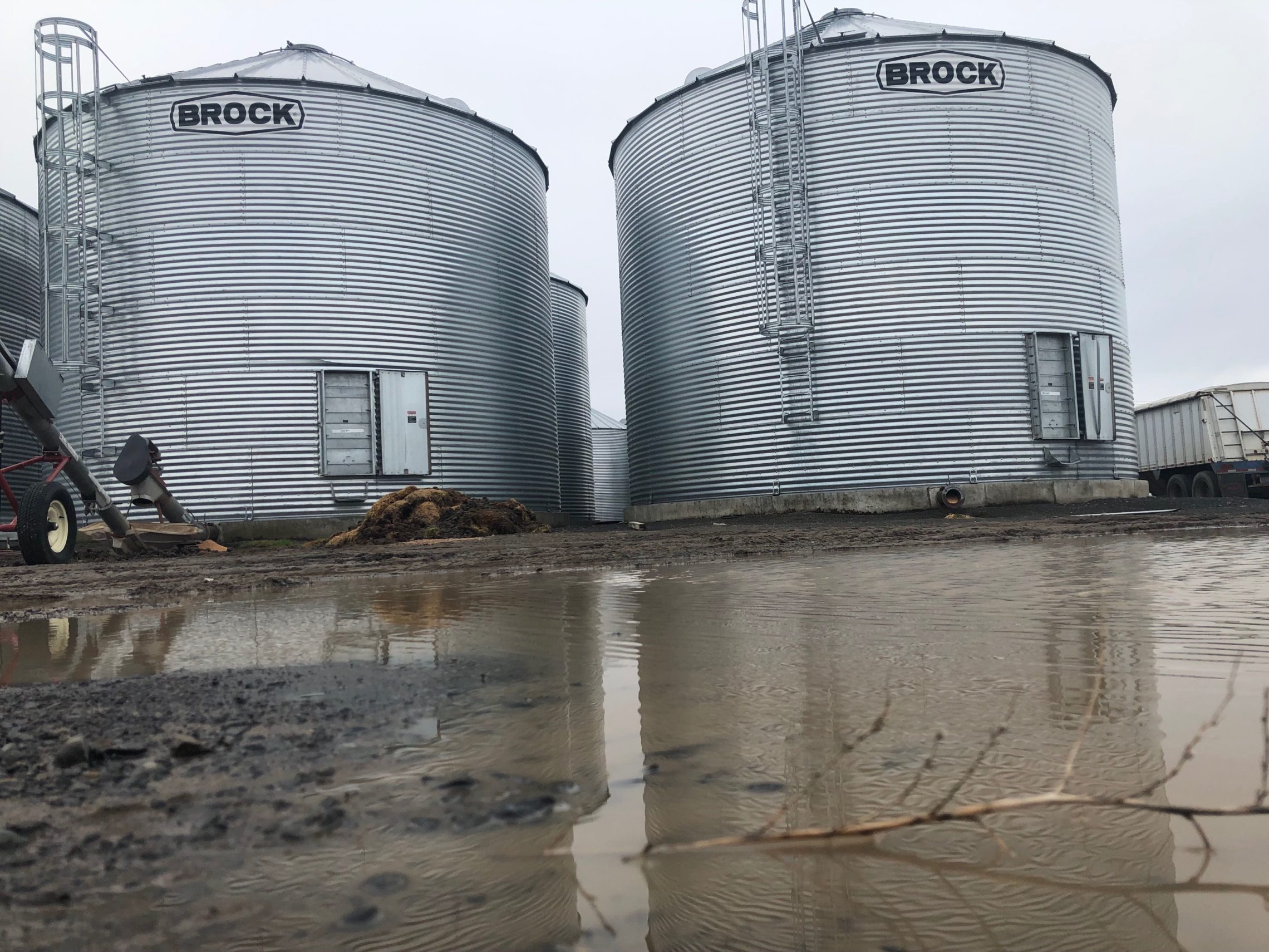 caption: Grain silos outside of Connell, Wash. reflect in the mud puddles left by heavy spring rains. CREDIT: ANNA KING/N3