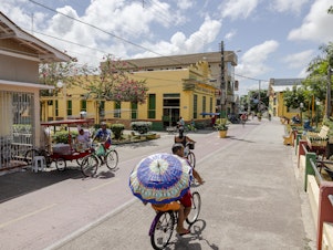 caption: People cycle along the street in Afuá, a city in northern Brazil's Pará state, in January. <strong></strong>Since 2002, this city on the banks of the Amazon River has been famously off limits to motor vehicles.