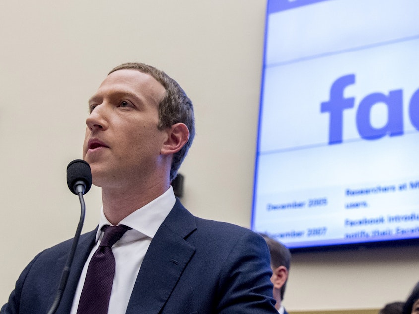 caption: Facebook CEO Mark Zuckerberg testifies before a House Financial Services Committee hearing in 2019.