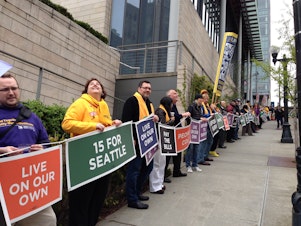 caption: Demonstrators in Seattle formed a human chain around City Hall in support of a $15 minimum wage in April. 