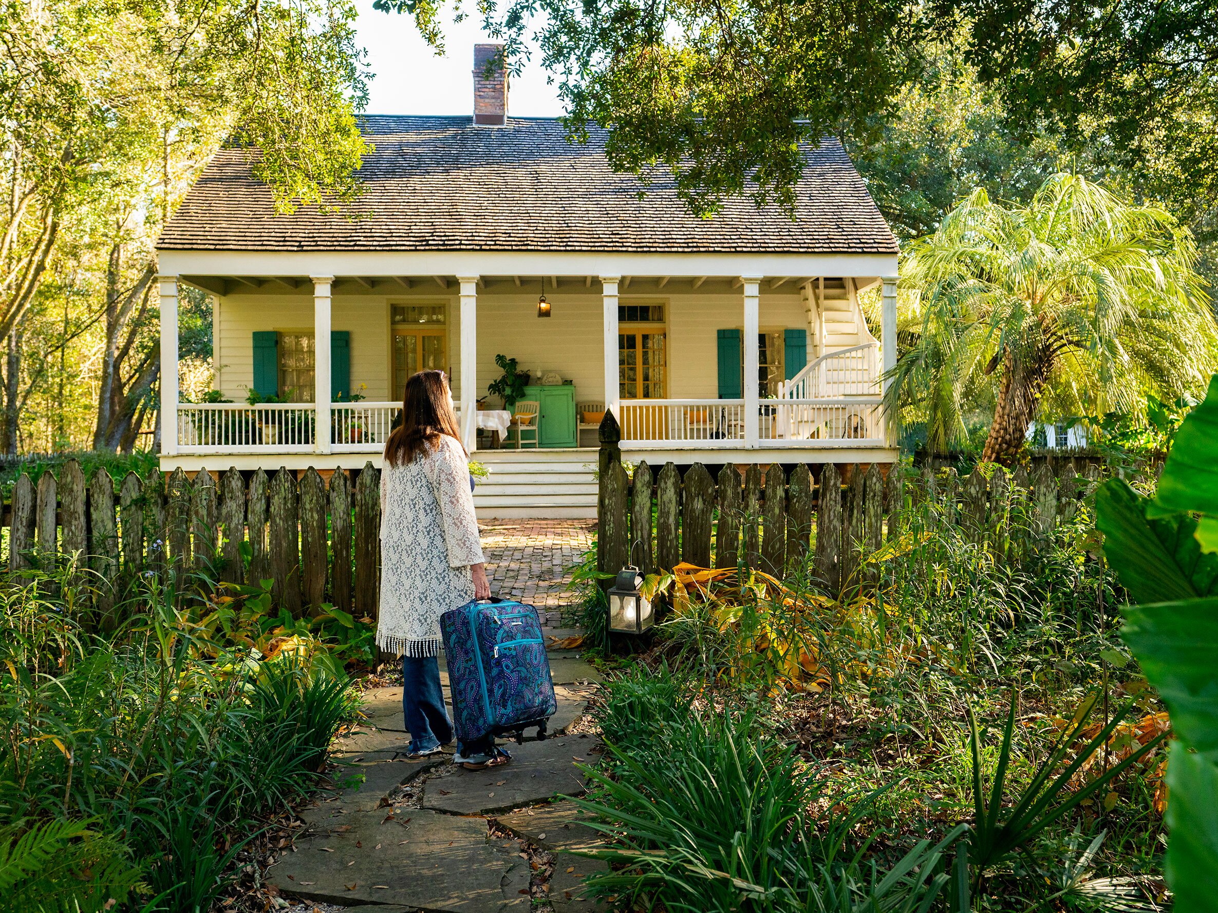 caption: As long as you're close enough with someone that you'd feel comfortable hosting them, you shouldn't feel sheepish about asking to stay with them when you're passing through their town, says etiquette expert Elaine Swann.