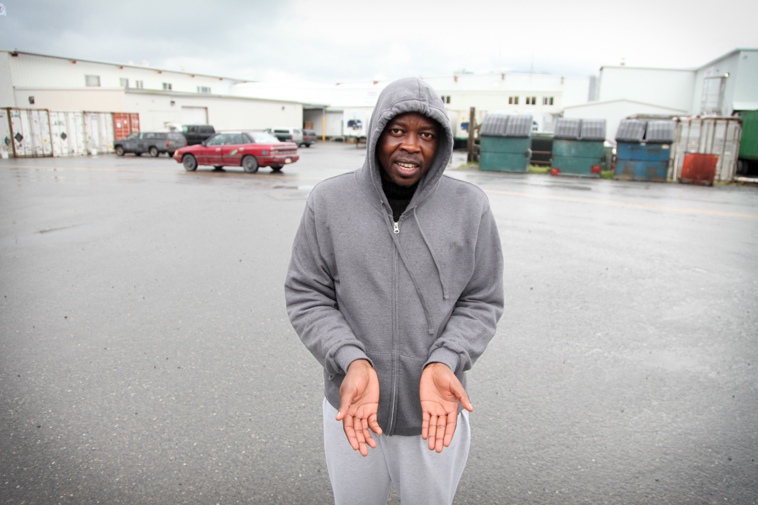 caption: Salahaldin Adam, outside the Trident North plant in Cordova. Adam is showing the swelling on his right hand, which he hurt after just a few weeks on the job. 