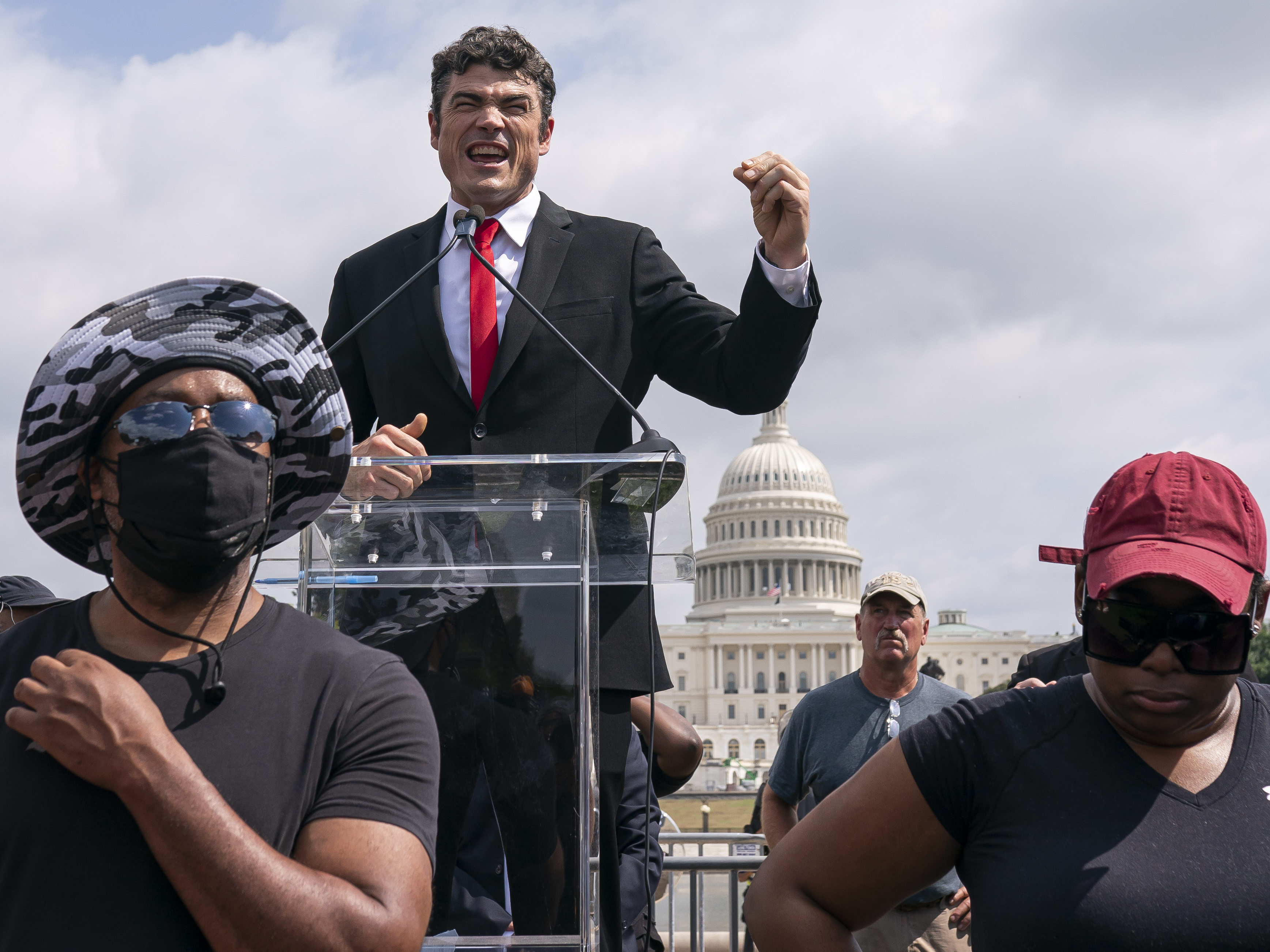 caption: Joe Kent, center, a Trump-endorsed Republican who is challenging Herrera Beutler, speaks during a "Justice For J6" rally near the U.S. Capitol in Washington, on Sept. 18, 2021, in support of people who took part in the Jan. 6 insurrection.