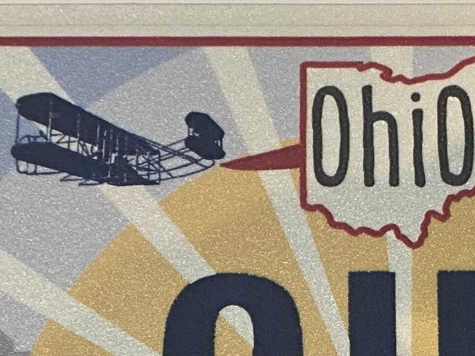 caption: The Wright Flyer as depicted on the new "Sunrise in Ohio" license plate.