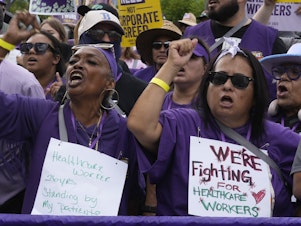 caption: Frontline health care workers hold a demonstration outside Kaiser Permanente Los Angeles Medical Center on September 4.