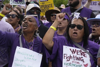 caption: Frontline health care workers hold a demonstration outside Kaiser Permanente Los Angeles Medical Center on September 4.