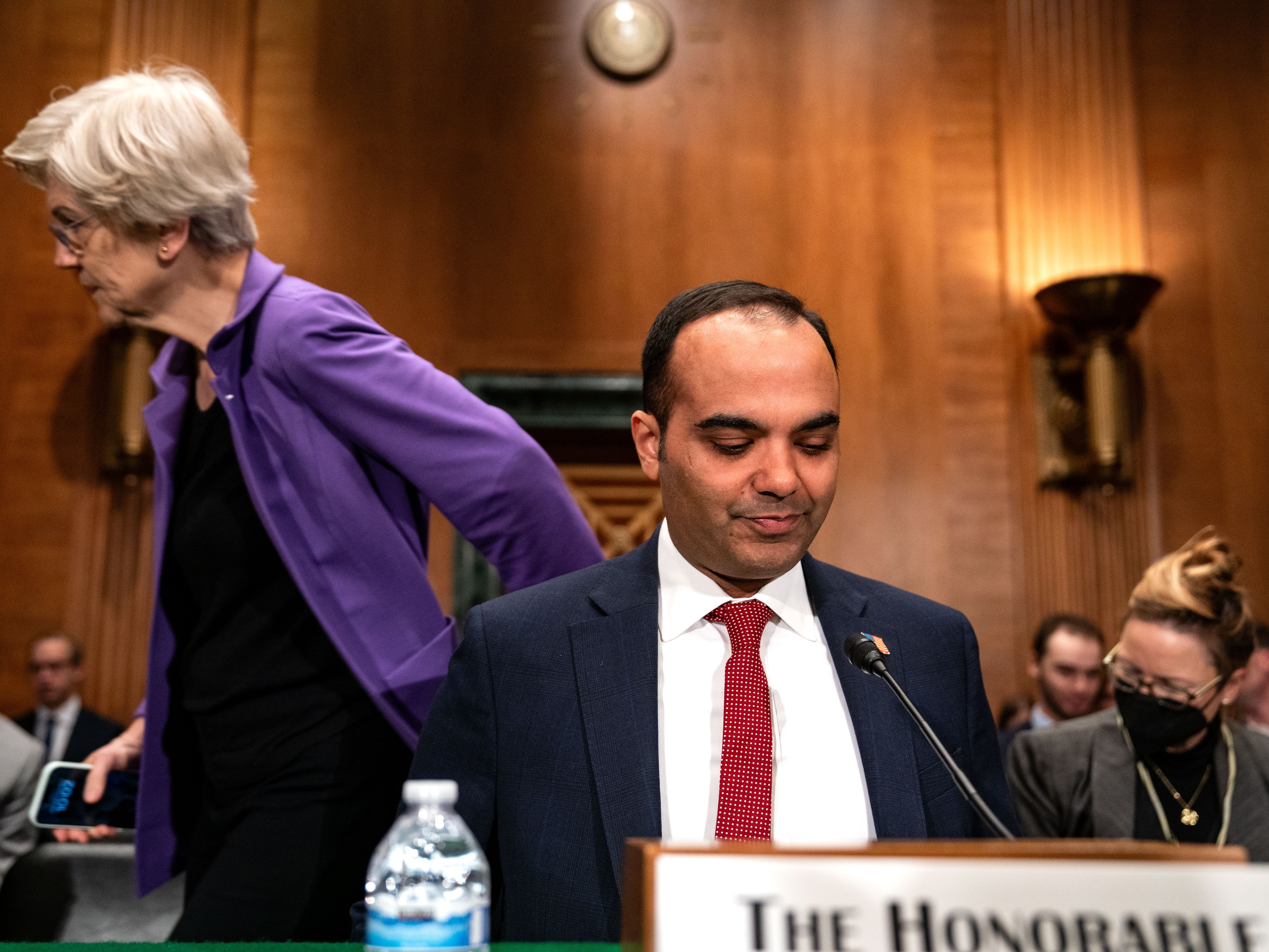 caption: Consumer Financial Protection Bureau (CFPB) Director Rohit Chopra arrives to testify before a Senate Banking, Housing, and Urban Affairs Committee hearing on Capitol Hill on December 11, 2024 in Washington, DC.