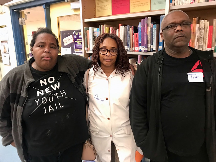 caption: K.L. Shannon (far left), and Denise Dailey and Tim Dailey want answers from Seattle Public Schools about why a teacher known to be abusive was hired at Washington Middle School — where, they said, he harmed their boys, too. 