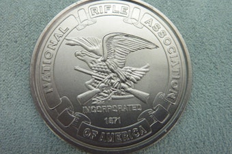 caption: A commemorative coin by the National Rifle Association.