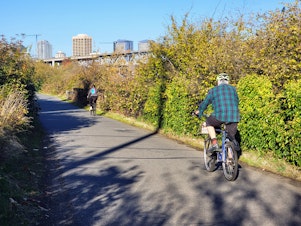 caption: Bicyclists on the Burke-Gilman Trail near U District on Thursday, October 5, 2023.