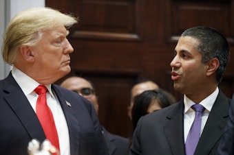 caption: President Trump talks with FCC Chairman Ajit Pai at the White House in November. Under Pai, the FCC repealed Obama-era net neutrality rules. A federal court is reviewing that decision in oral arguments.
