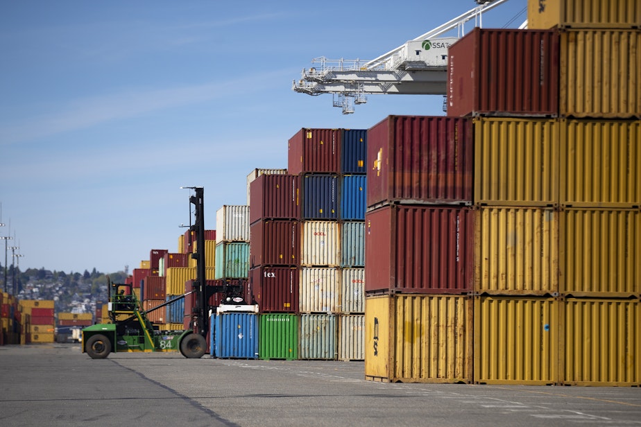 caption: Shipping containers are moved on Monday, May 5, 2025, at the Port of Seattle’s Terminal 5.
