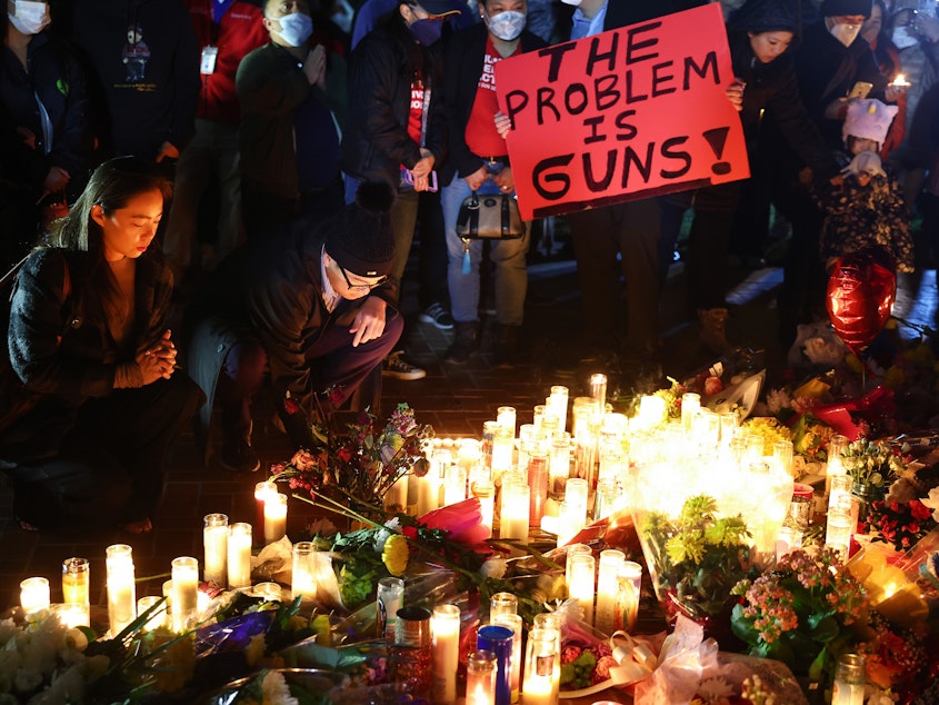 caption: People attend a candlelight vigil for victims of a deadly mass shooting on Jan. 24 in Monterey Park, Calif. President Biden will announce his latest gun safety push there on Tuesday.