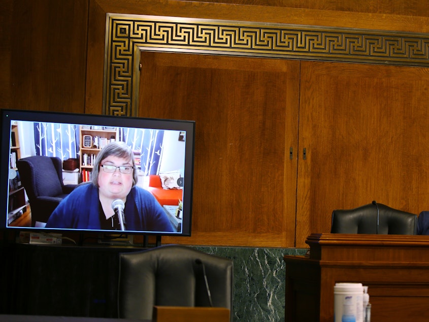 caption: Disinformation researcher Joan Donovan testifying remotely during a U.S. Senate hearing in April 2021. Donovan contends she lost her job at Harvard University due to pressure from the social media company, Meta.
