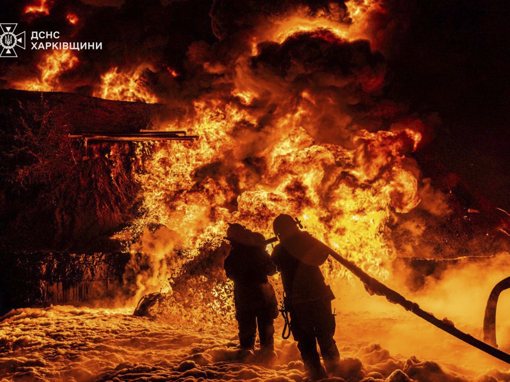 caption: In this photo provided by the Ukrainian Emergency Service, emergency services personnel work to extinguish a fire following a Russian attack in Kharkiv region, Ukraine, Saturday, July 5, 2025.