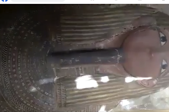 caption: Screenshot of video on Facebook showing an Egyptian sarcophagus with mummy inside for sale. According to the ATHAR Project, the video is from an area known for extensive antiquities looting. Facebook bans trade in antiquities and human remains, but relies on user reports to flag suspect items. This post, reported by ATHAR using the Facebook system, was not deemed to violate Facebook's standards.
