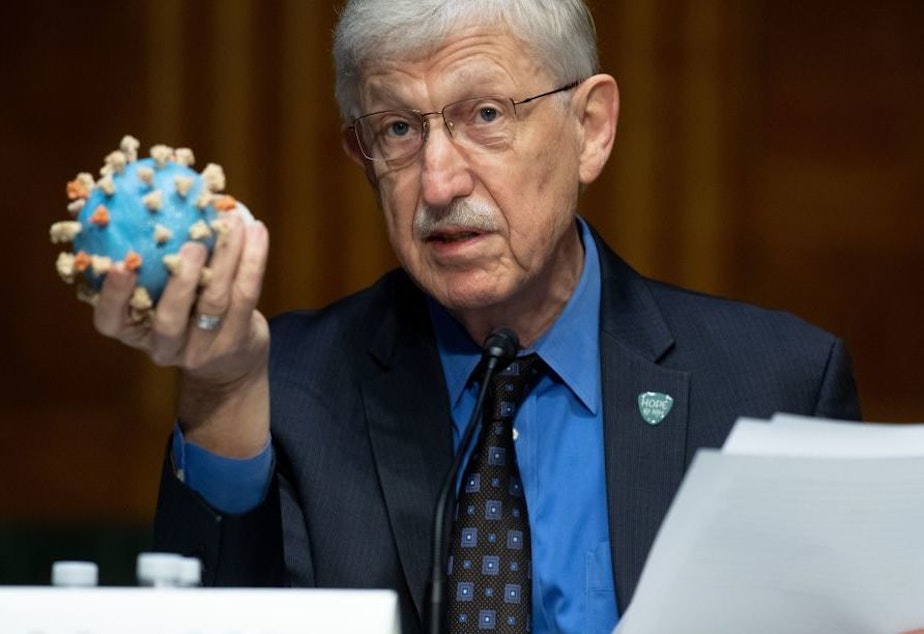 caption: Director of the National Institutes of Health, Dr. Francis Collins, holds a model of the coronavirus. This is the sixth vaccine candidate to join Operation Warp Speed's portfolio, and the largest vaccine deal to date.