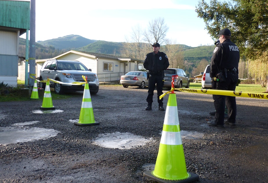caption: Nooksack tribal police stand outside the courthouse during a disenrollment hearing.