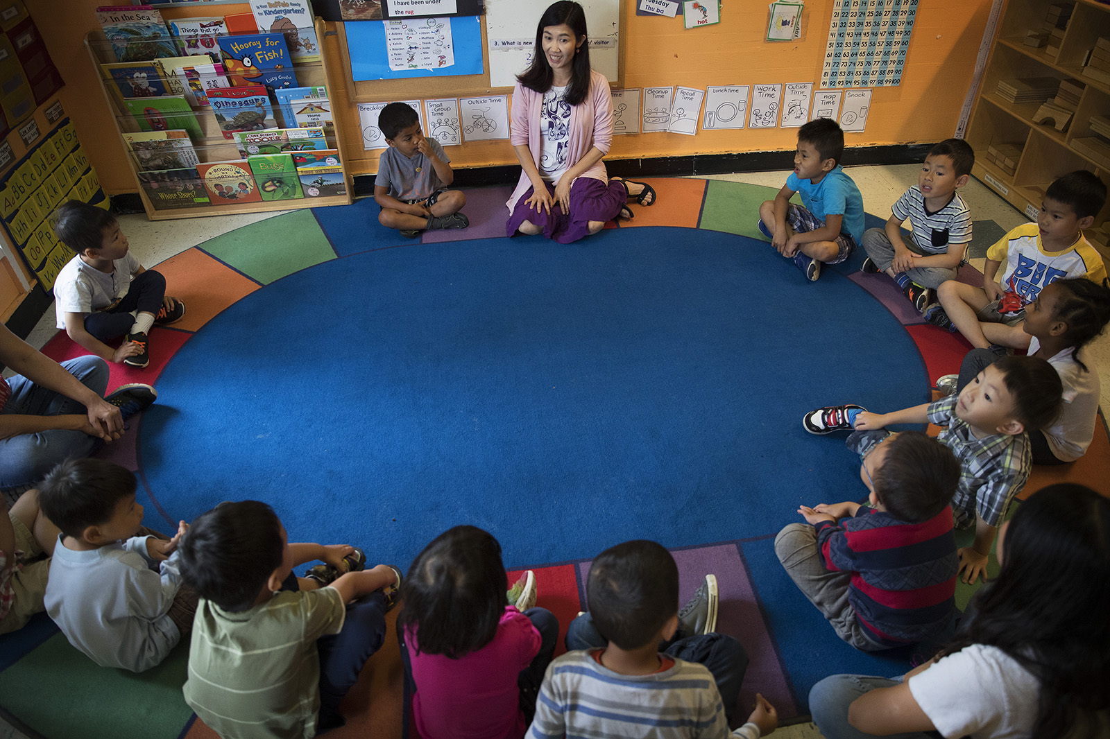 caption: Seattle Preschool Program teacher Hien Do, center, sits in a circle with her students on Wednesday, June 28, 2017, at the ReWA Early Learning Center at Beacon, in Seattle, Washington. 