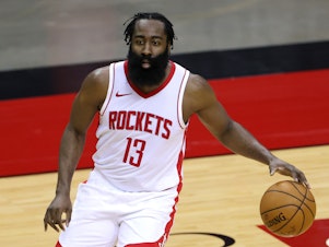 caption: James Harden of the Houston Rockets was fined $50,000 for violating the NBA's health and safety protocols. He's seen on the court during a preseason game against the San Antonio Spurs on Dec. 17.