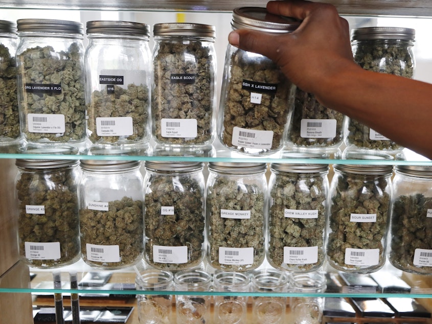 caption: Michigan has become the first state in the Midwest to legalize recreational marijuana, after voters approved a ballot measure Tuesday. Here, a clerk reaches for a container of marijuana buds at Utopia Gardens, a medical marijuana dispensary in Detroit.