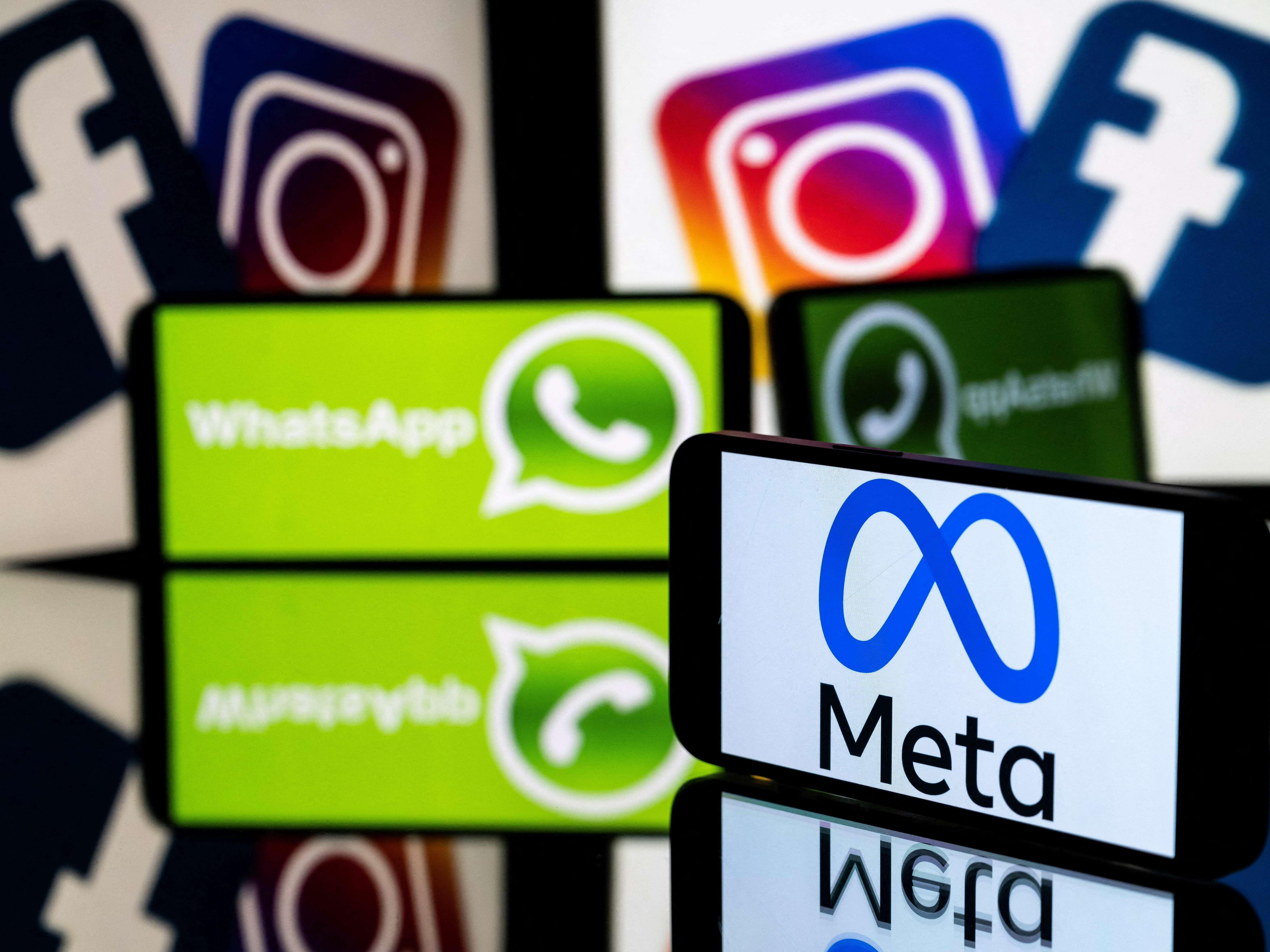caption: This picture taken on January 12, 2023 in Toulouse, southwestern France shows a smartphone and a computer screen displaying the logos of the Instagram, Facebook, WhatsApp and their parent company Meta.