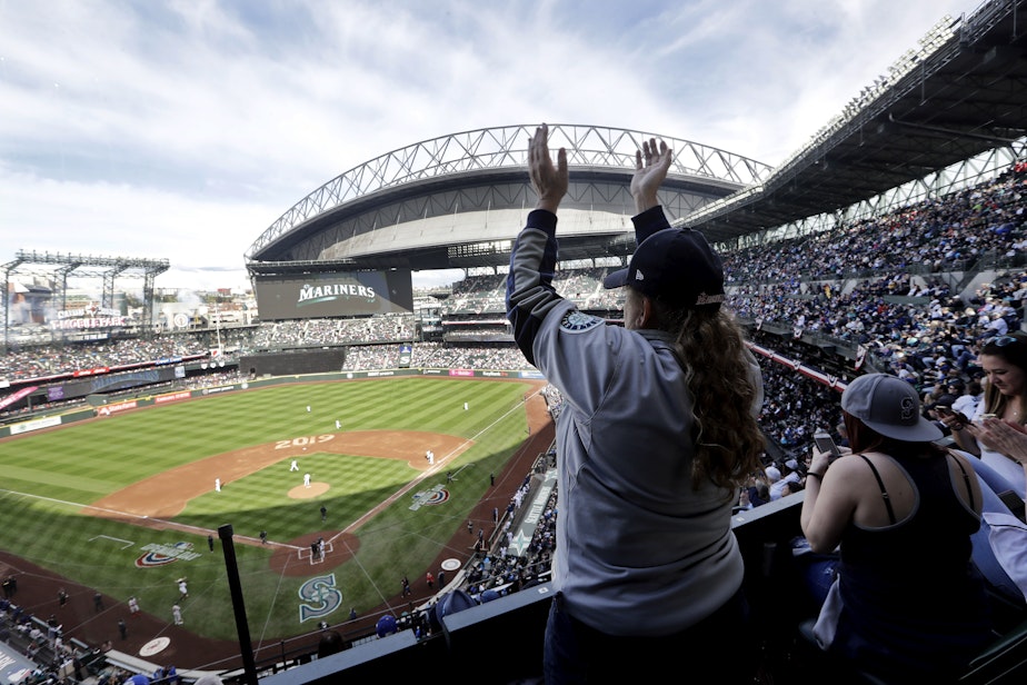 caption: A Seattle Mariners' fan cheers before the Mariners' home season opening baseball game against the Boston Red Sox Thursday, March 28, 2019, in Seattle. 