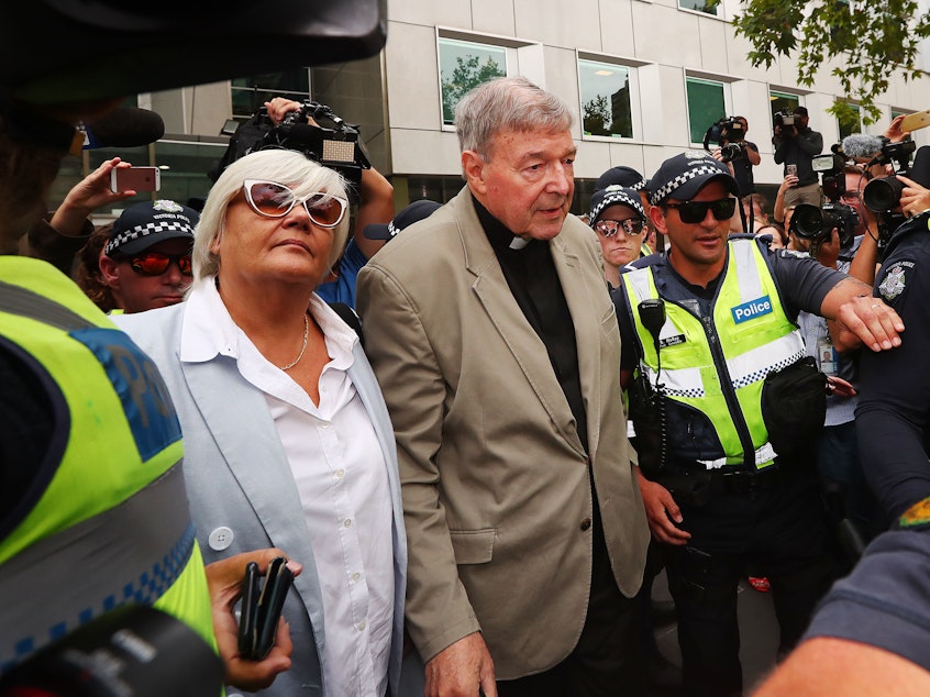 caption: Cardinal George Pell leaves the court in Melbourne, Australia. Pell was convicted on five counts of child sexual assault in December 2018 but that verdict has just been released in Australia.