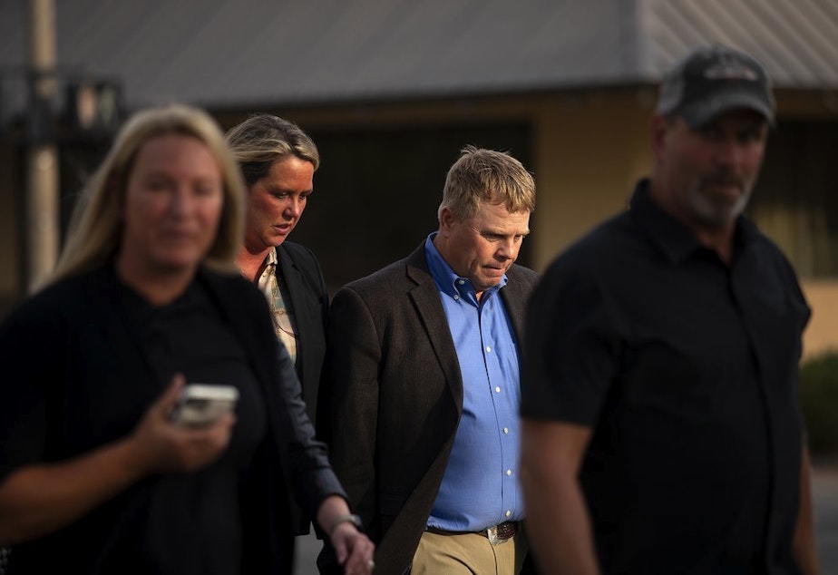 caption: Cody Easterday walks with family members from the Federal Courthouse on South Third Street after being sentenced to 11 years, on Tuesday, October 4, 2022, in Yakima, Wash.