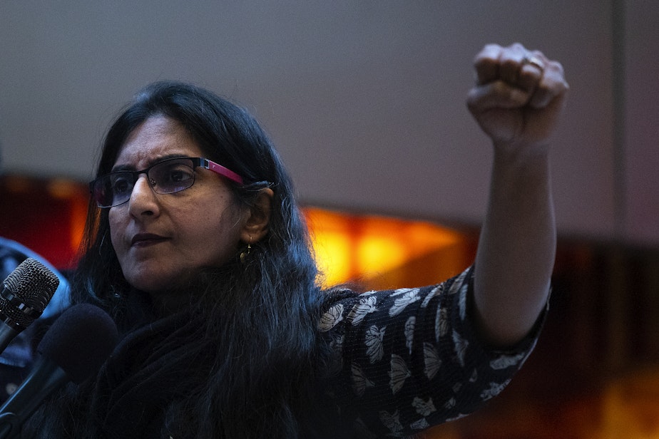 caption: Seattle city councilmember Kshama Sawant holds a fist in the air while speaking during a rally ahead of a Seattle city council vote on a measure, proposed by Sawant, that would ban discrimination based on caste, on Tuesday, February 21, 2023, at Seattle City Hall. Seattle would be the first city in the nation to do so. 