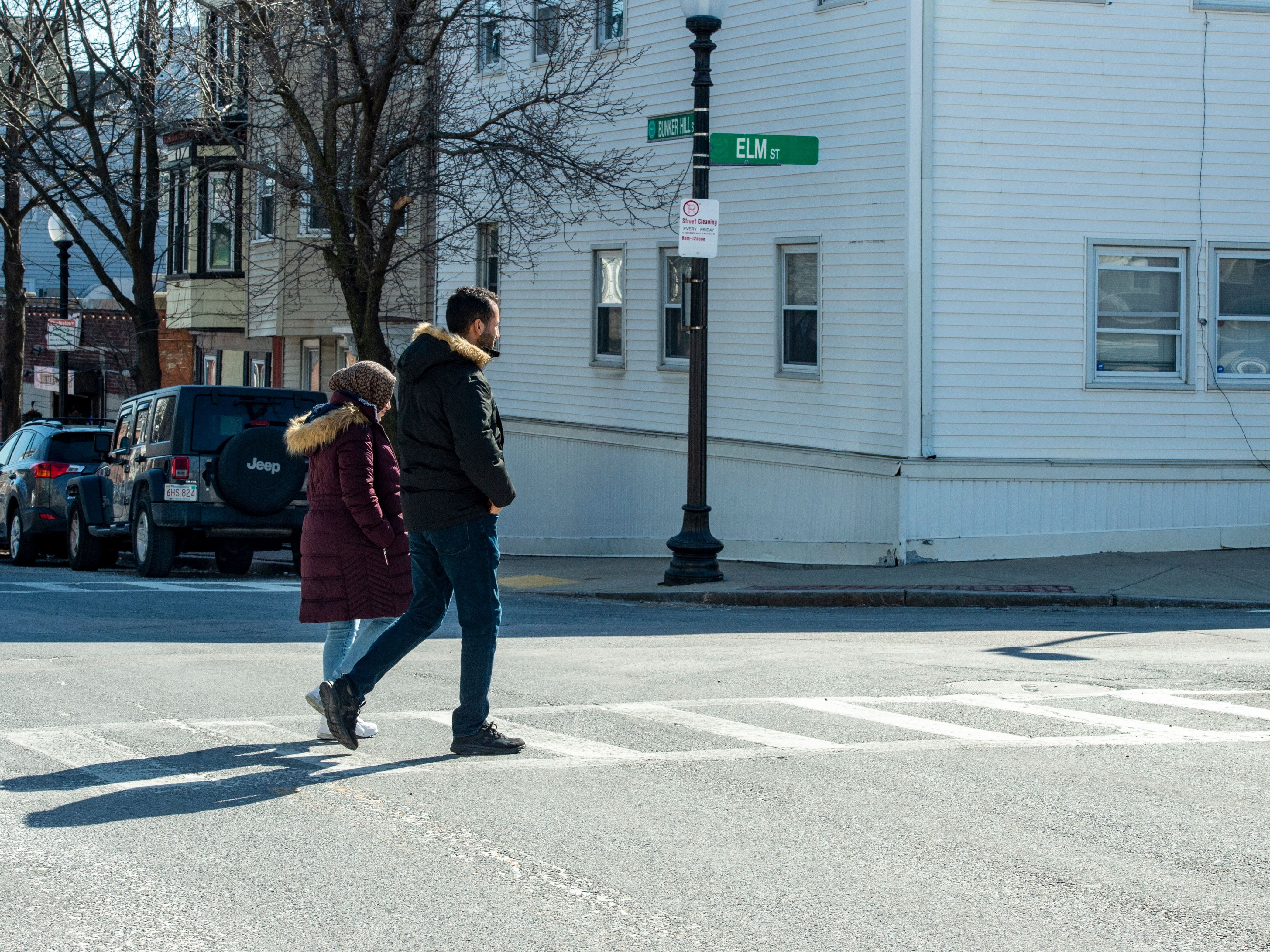 caption: Afghani evacuees walk to a dentist appointment in Charlestown, Mass.