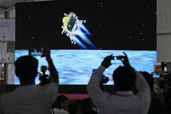 caption: Journalists film the live telecast of spacecraft Chandrayaan-3 landing on the moon at ISRO's Telemetry, Tracking and Command Network facility in Bengaluru, India, on Wednesday, Aug. 23, 2023.