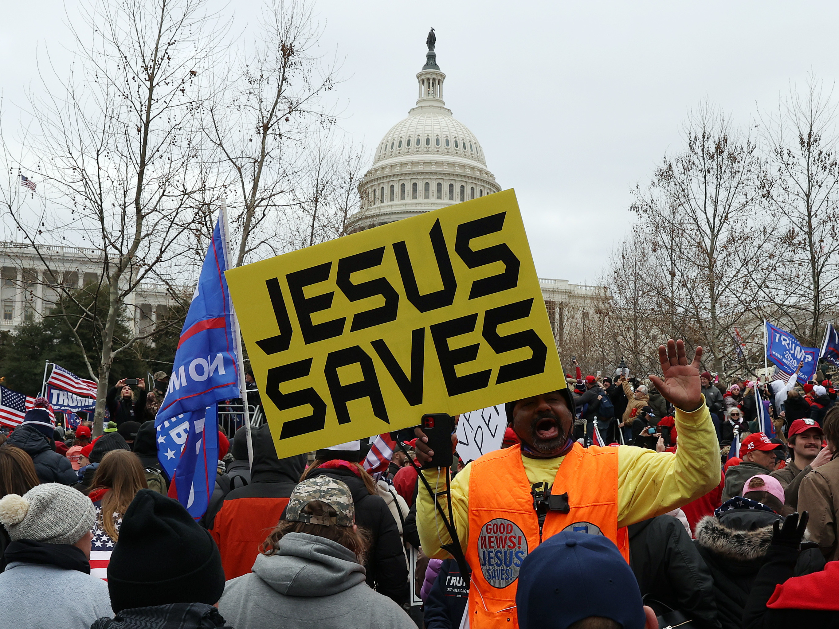 caption: Protesters gather outside the U.S. Capitol on Jan. 6 in Washington, D.C., some with signs and symbols of Christianity. Pro-Trump protesters entered the U.S. Capitol that day after mass demonstrations in the nation's capital.