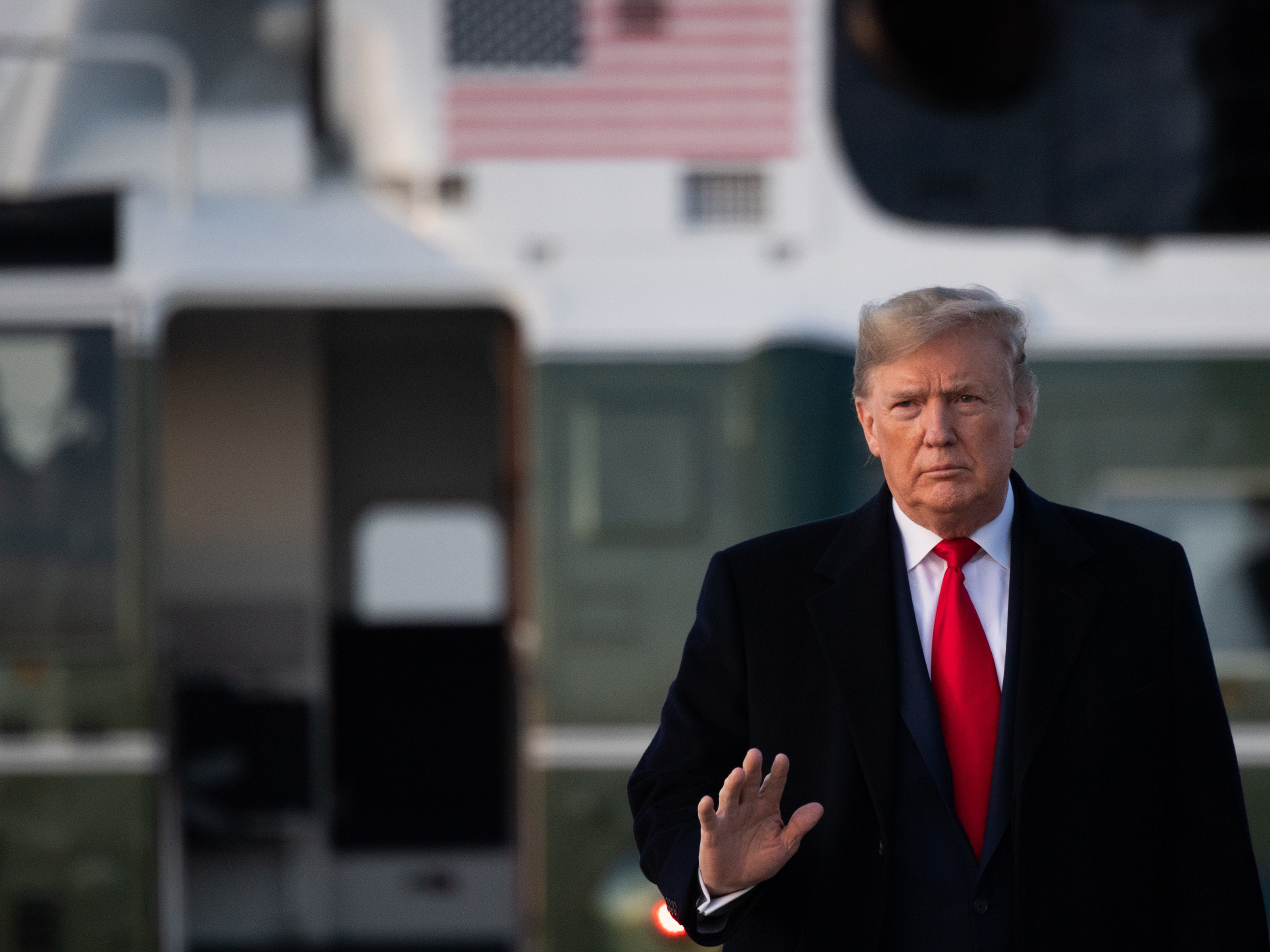caption: President Trump boards Air Force One Thursday on his way to Toledo, Ohio, to hold a campaign rally.