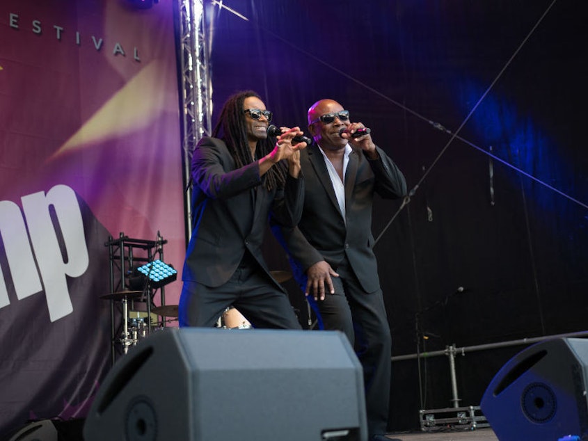 caption: John Davis (right), on stage with former Milli Vanilli star Fabrice "Fab" Morvan, in Eisenach, Germany in 2018.