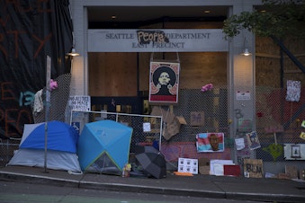 caption: The exterior of the Seattle police department's East Precinct building is shown on Saturday, June 13, 2020, in Seattle. 