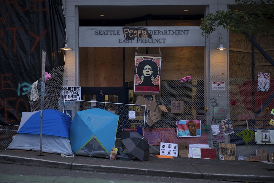 caption: The exterior of the Seattle police department's East Precinct building is shown on Saturday, June 13, 2020, in Seattle. 