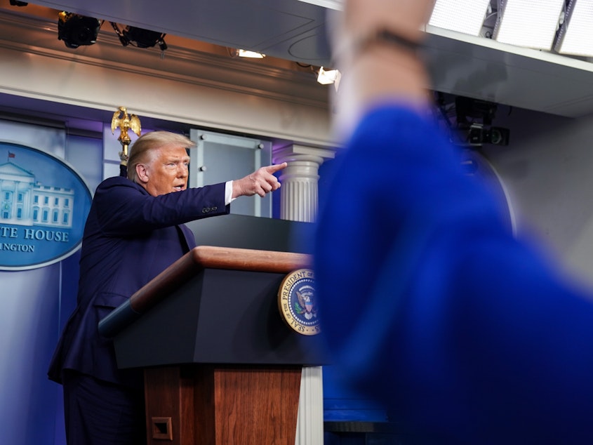 caption: President Trump takes a question during a news conference at the White House on Sunday, where he dismissed reporting from the "New York Times" that he has paid little or no federal income taxes in recent years as "fake news."
