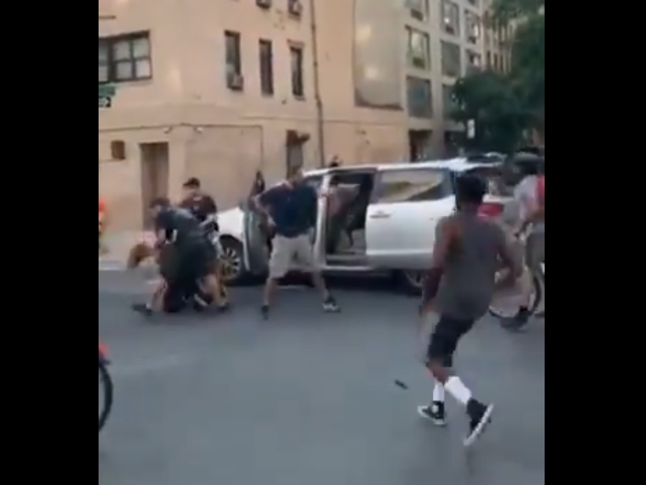 caption: A video posted to social media shows police detain a woman during a New York City protest and shove her into an unmarked van.