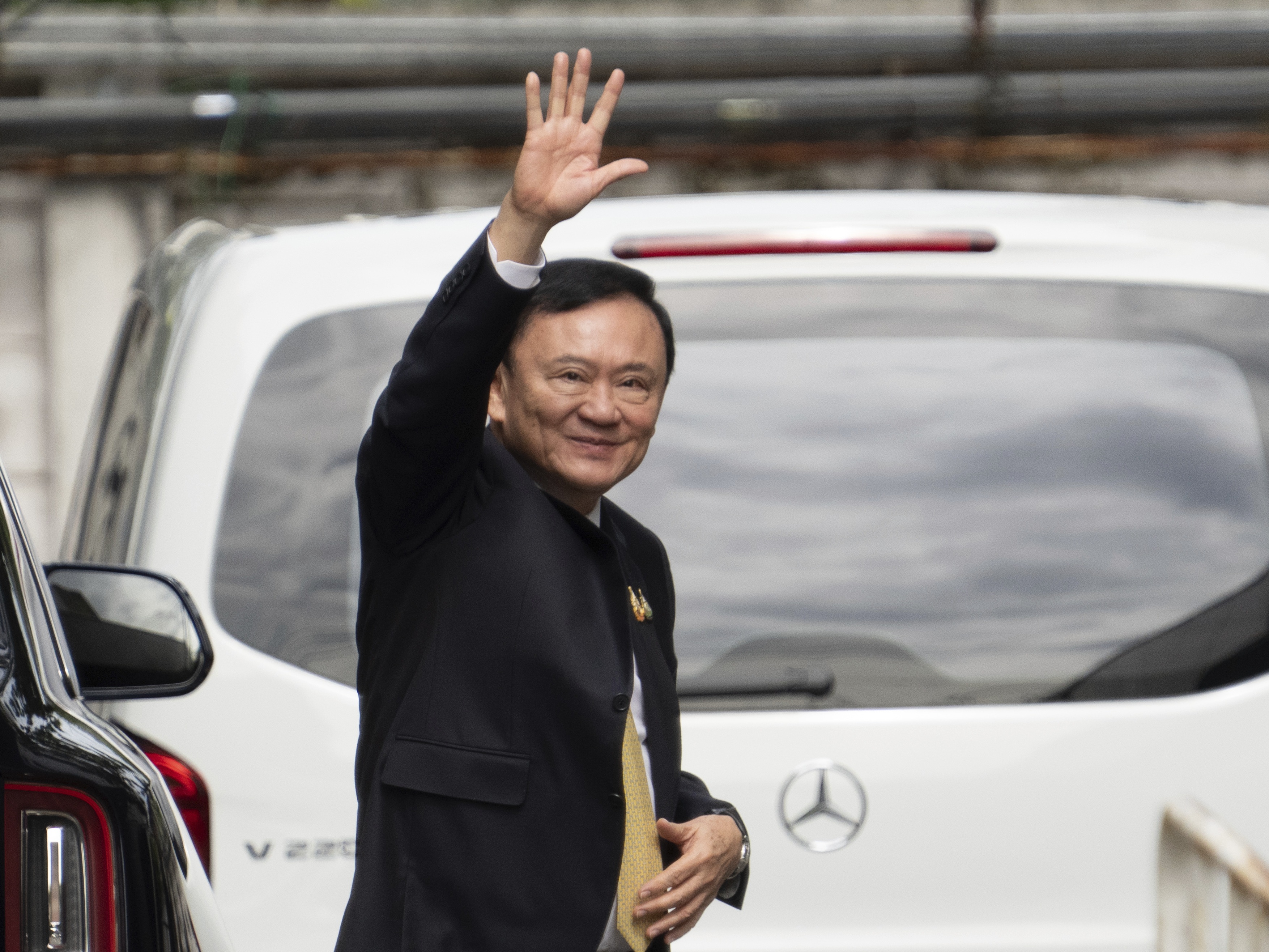 caption: Former Thai Prime Minister Thaksin Shinawatra arrives at Criminal Court for a verdict for allegedly defaming the monarchy in Bangkok on Friday, Aug. 22, 2025.