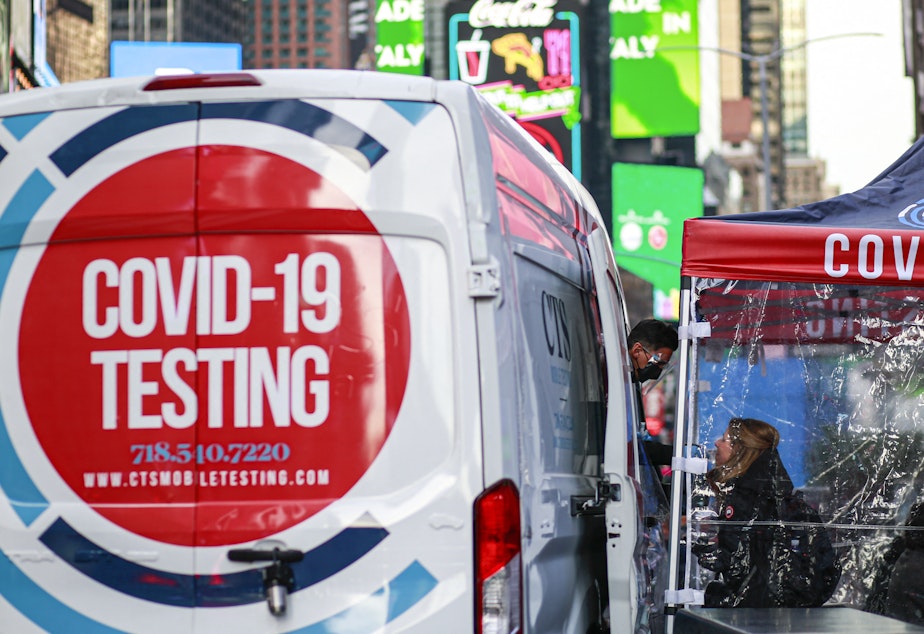 caption: A COVID-19 testing site is pictured in Times Square, New York city on December 5, 2021.